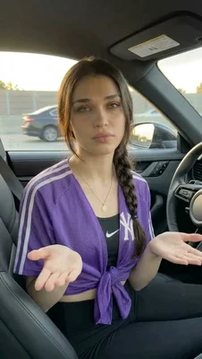 Young woman in a car expressing uncertainty