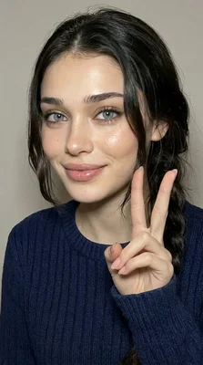 Young Woman with Braided Hair and Peace Sign Gesture