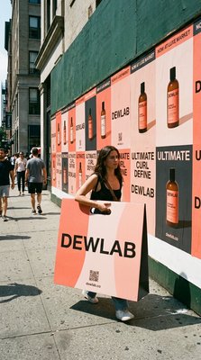 Street Advertisement for Dewlab Hair Products in Urban Setting