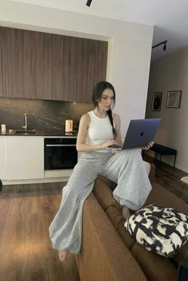 Young woman working on laptop in stylish modern kitchen