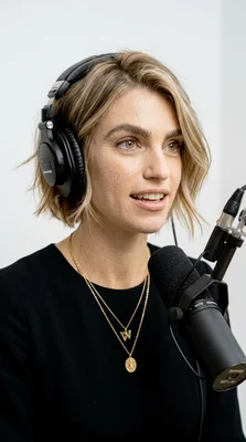 Woman with Headphones Speaking into Microphone