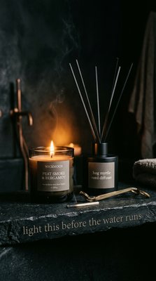 Cozy Aromatic Scene with Candle and Reed Diffuser