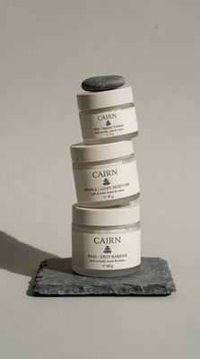 Elegant Skincare Product Stack with Stones